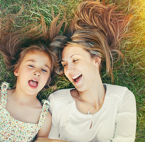 mother-and-daughter-laying-in-grass
